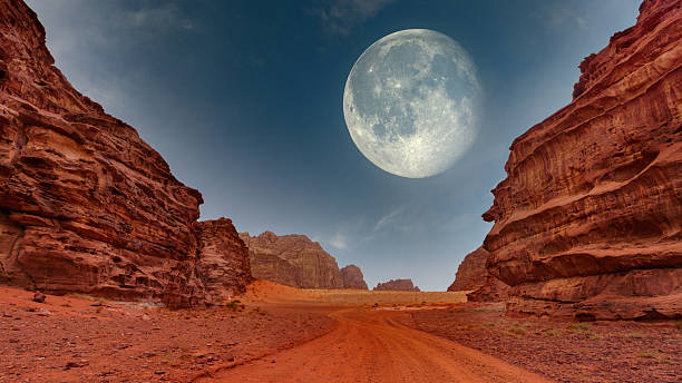 istock Stunning desert landscape under a full moon with towering rock formations and a deep blue sky 2233739736