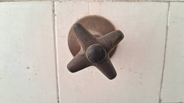 istock Old, cross-shaped faucet handle with a circular base 2233740458