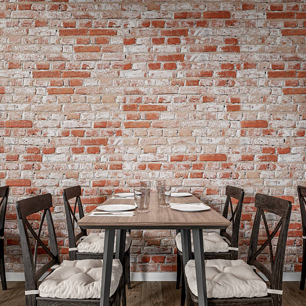 istock Cozy restaurant interior with a rustic exposed brick wall and wooden furniture (tables and chairs), empty brick wall background with copy space 2233740802