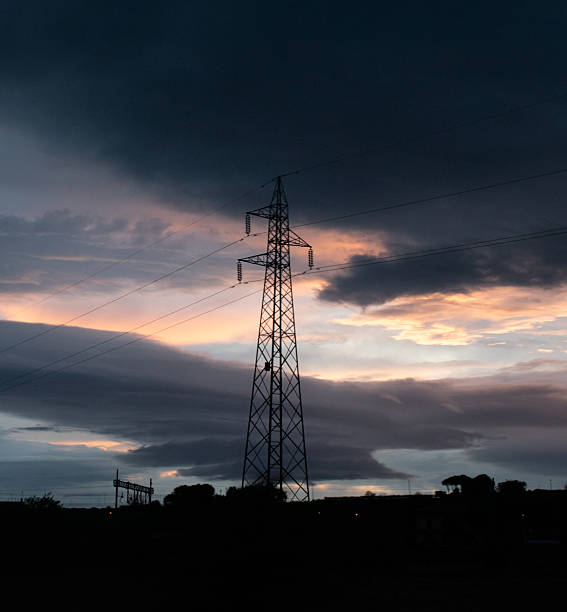 istock High Voltage Electric Tower Against a Menacing Evening Sky 2233744098