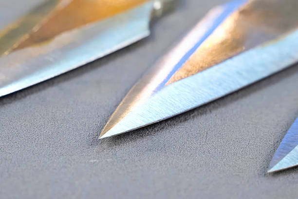 istock Sharpened and polished homemade throwing knives making cold weapons. 2233745513
