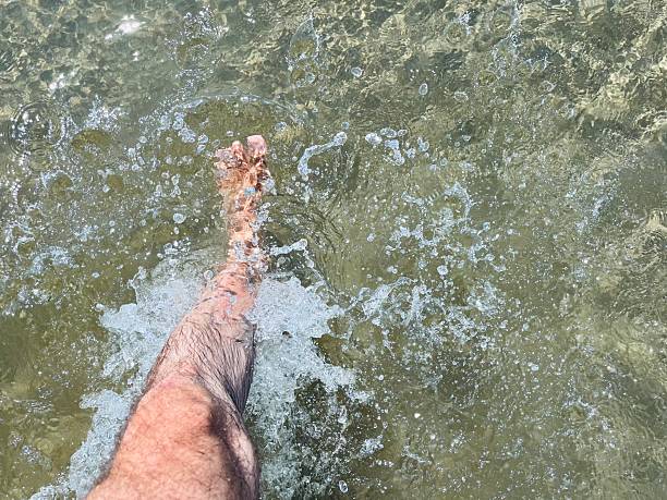 Male leg while walking in sea water