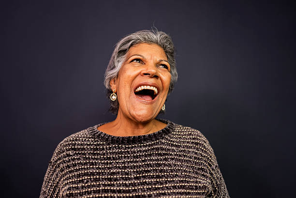 istock Senior woman laughing in a studio shot 2233746098