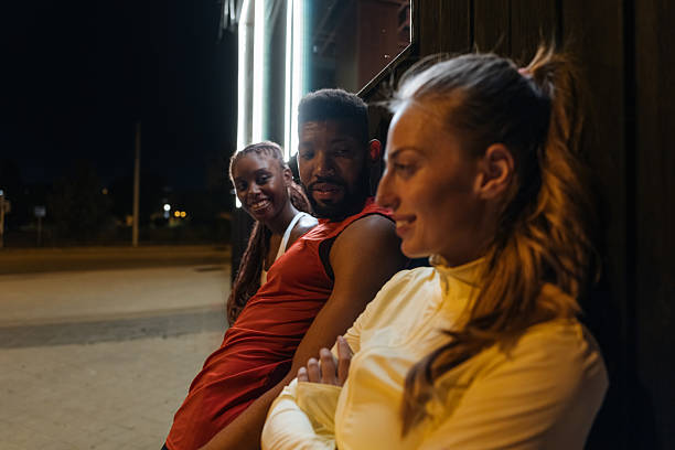 istock Fitness Friends Relaxing Together After Night Workout 2233746410