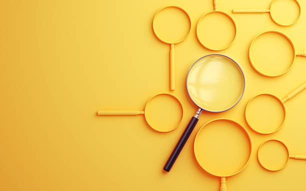 istock Metallic Magnifier Selected Among Solid Yellow Magnifiers on Soft Yellow Background 2233746864