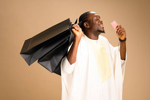 istock Man with agbada holding shopping bags and card 2233746939