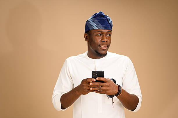 istock Man in Yoruba cap holding smartphone in studio 2233748181