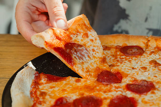 istock Tasty Italian pepperoni pizza on wood table. 2233751679