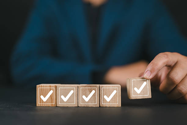 istock Work Progress Loading Bar with Checklist. Man places a wooden block with a checkmark into a loading bar with 5 checkboxes, symbolizing progress, task completion, and project workflow development. 2233751925