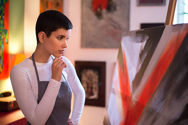 istock Young woman painter painting at home 2233752690