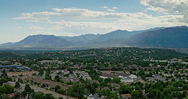 istock Sunlight Shining Through Storm Clouds On Rocky Mountains and Colorado Springs 2233753447