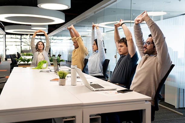 istock Business people taking a break from work and doing stretching exercises at the office 2233753777