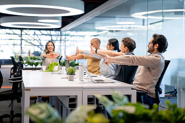 istock Group of coworkers stretching while taking a break at the office 2233753780