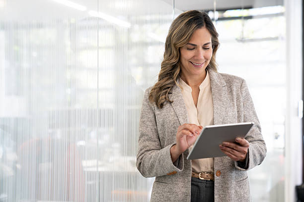 istock Businesswoman using a digital tablet while working at the office 2233753880