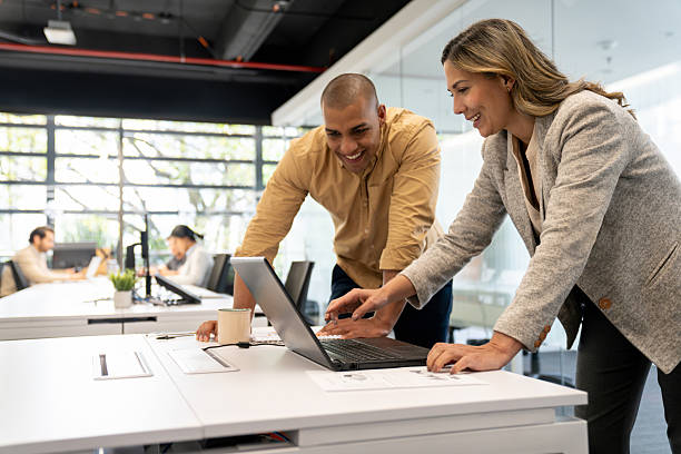 istock Business people working together at the office using a laptop computer 2233753882