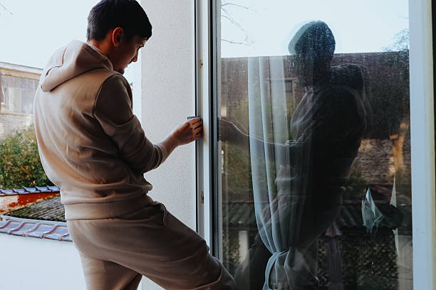 istock One person washes a window frame with a rag on the second floor. 2233753957