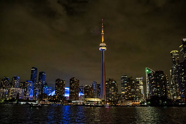 Magnificent night view of the brilliantly lit iconic city skyline of Toronto with the CN tower seen from Toronto Island on Lake Ontario in Toronto,Ontario,Canada
