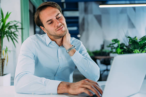 istock Businessman massaging his neck while working in the office. 2233762261