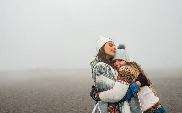 Friendly embrace in a cold and foggy landscape
