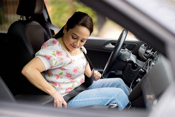 istock Woman fastening seat belt while sitting in car 2233771306