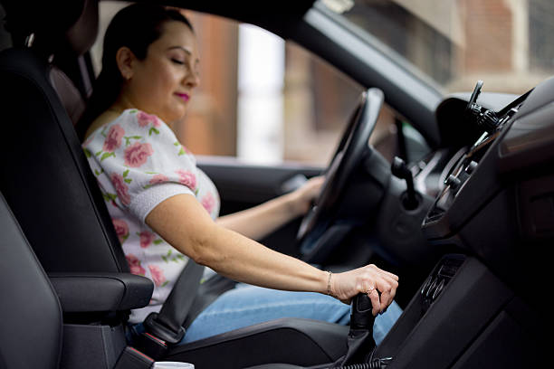 istock Woman shifting gears while driving a car 2233771309