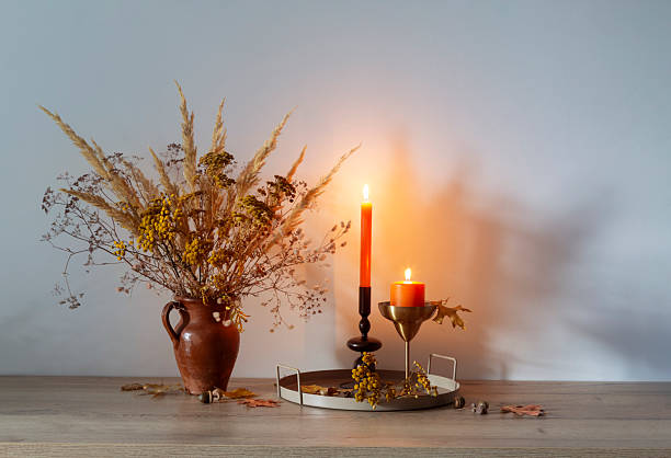 istock autumn bouquet with burning candles on background whiite wall 2233771471