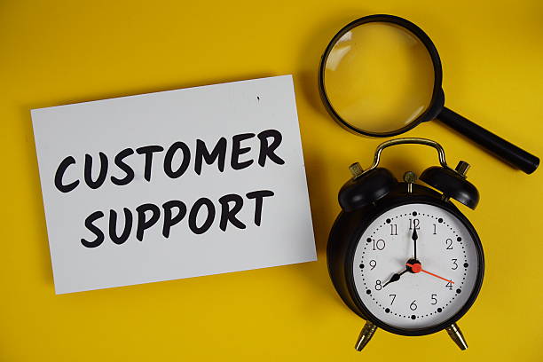 istock Customer Support letters with magnifying glass and alarm clock flat lay on yellow background 2233776676