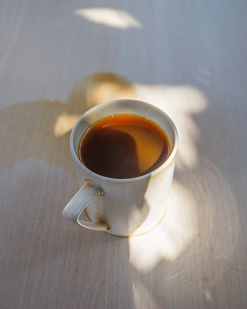 istock Coffee cups and liquids spilled on the wooden table. 2233776744