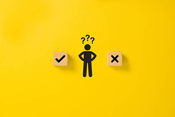istock Decision making and choosing between the right and wrong. Confusion about to accept or to reject. Stickman with question mark standing in between the wooden cubes with check mark and x symbols 2233776803
