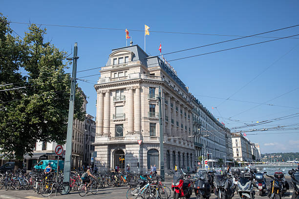 Geneva, Switzerland- July 3, 2025: Street view in Geneva. People are walk or ride on the street. City buildings are on the backgroud.