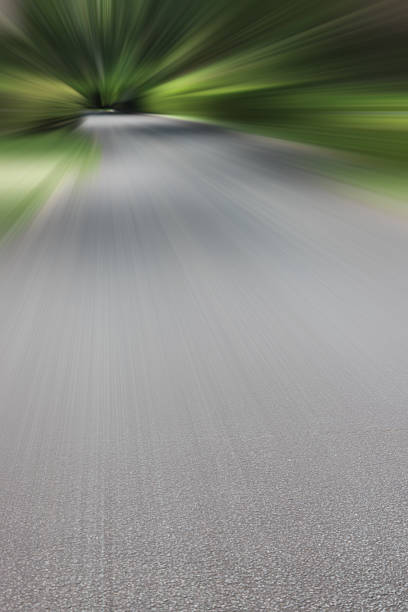 istock Asphalt road through the forest with motion blur effect. 2233780933
