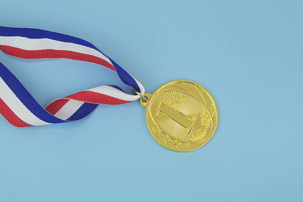 istock Gold medal with ribbon on blue 2233782773