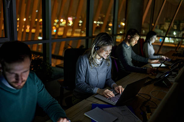 istock Business people working on laptops late in a call center. 2233783082