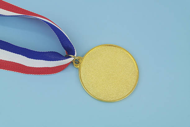 istock Gold medal with ribbon on blue 2233783087