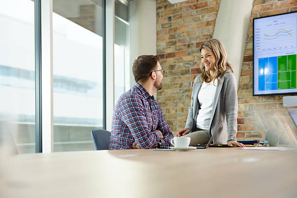 istock Happy business colleagues talking while working in the office. 2233783550