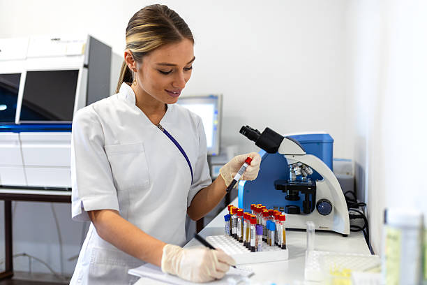 istock Medical Science Laboratory: Beautiful Scientist Looking Under Microscope Does Analysis of Test Sample. Young Specialists, Using Advanced Technology Equipment 2233784501