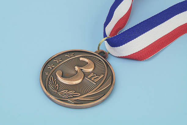 istock Bronze medal with ribbon on blue 2233784827