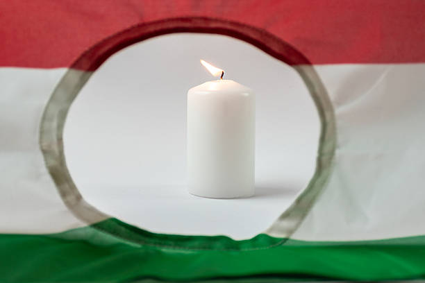 istock Hungarian flag and burning white candle 2233788439