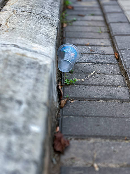 istock Plastic Cup Littering Urban Pavement Highlighting Environmental Concerns 2233791843