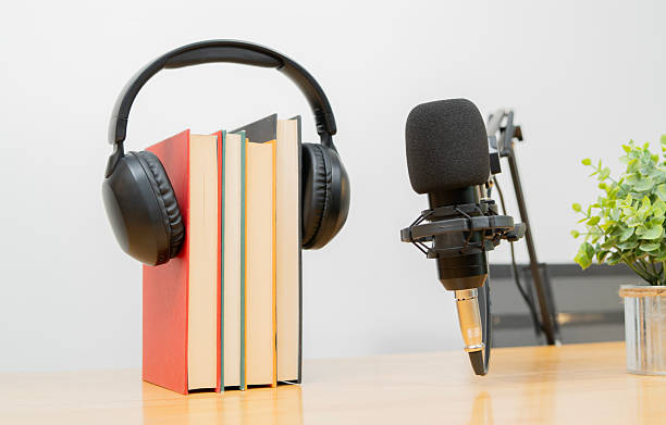 istock A professional microphone stands with book and headphone for recording or broadcasting 2233791905