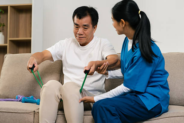 istock senior man doing exercise at clinic with physiotherapist. help of a personal trainer during a rehabilitation session. 2233794633