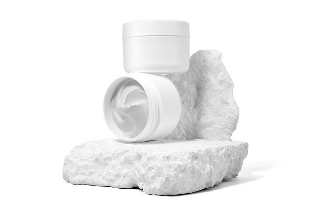 istock White plastic cosmetic jar with stone for mockup isolated on white background. Selective Focus. 2233795564
