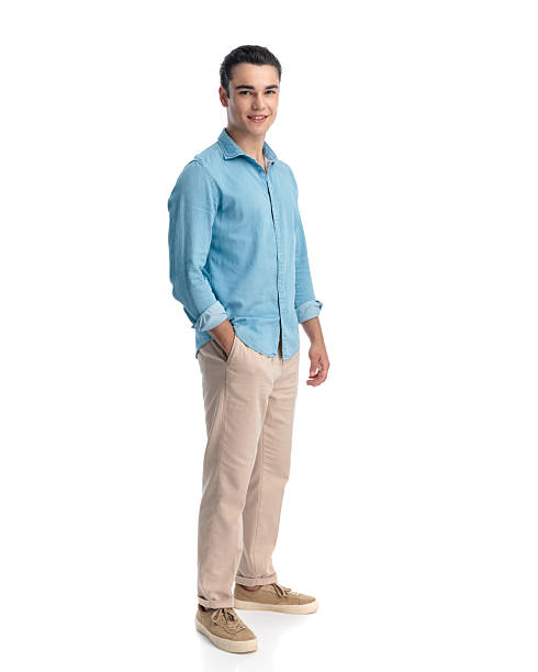 istock handsome young guy in blue jeans shirt standing and smiling 2233795760