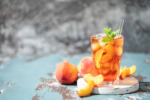 istock Peaches iced tea  in a glass on the table. Summer drink concept 2233796293