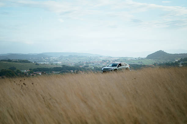 A generic SUV car on a rural road in a mountain area