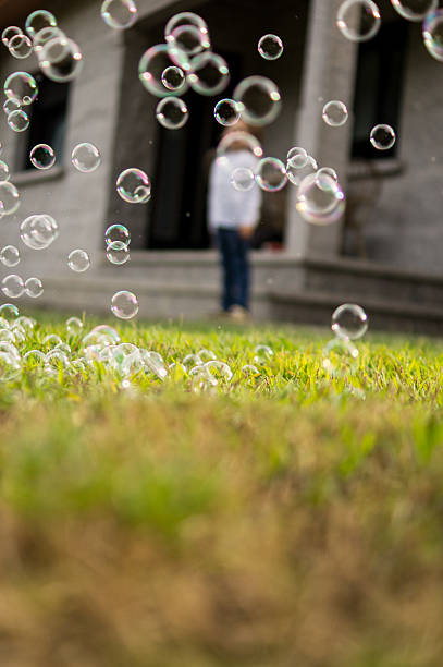 out-of-focus child looking at soap bubbles from a distance