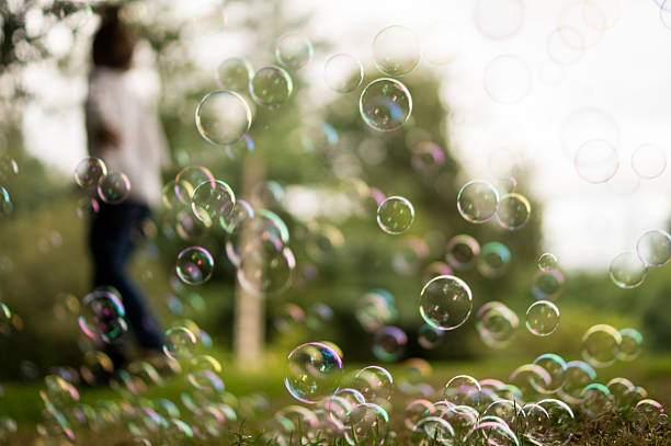 istock Blurred boy playing with soap bubbles at a children's birthday party 2233800054