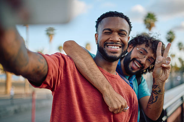 istock Two young men taking a selfie and smiling at the camera 2233801247