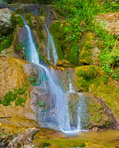 istock small waterfall on mountain river flow through canyon covered by red dry leaves 2233803828