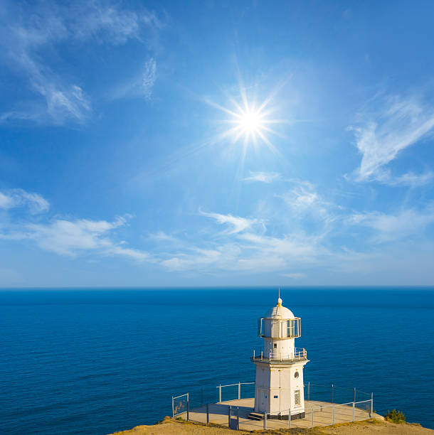 alone white lighthouse stay on sea cape at the summer sunny  day